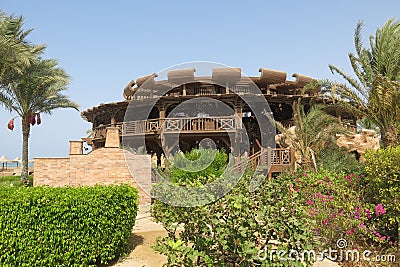 Wooden round building on the beach by the Red Sea. Atypical shape restaurant in Egypt. Exterior view of a pub made of natural Stock Photo