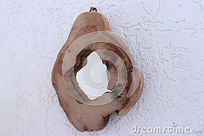 Wooden round shaped mirror on white wall Stock Photo