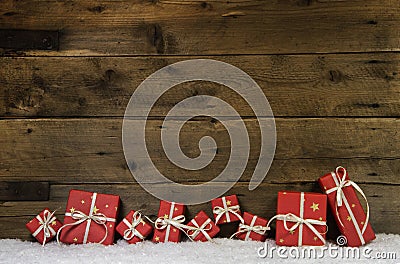 Wooden rustic background with red christmas presents. Stock Photo