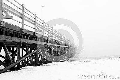 Wooden scary bridge disappearing in the fog. Bridge leading to nowhere. Stock Photo