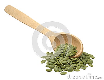 Wooden scoop with green pumpkin seeds isolated on white background. Diagonal layout Stock Photo