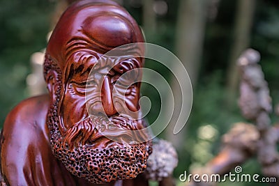 Wooden sculpture of an old Chinese man Editorial Stock Photo