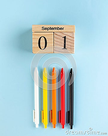 Wooden September 1 calendar, colored pens on a blue background. Art concept of the beginning of the school year Stock Photo