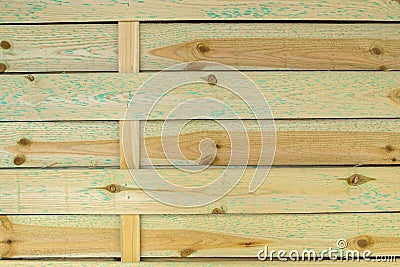 Wooden shield consisting of horizontally located, covered with knots and traces of cuts of wide yellow boards with blue spots Stock Photo
