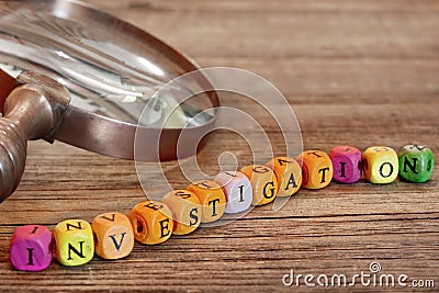 Wooden Sign INVESTIGATION and Old Magnifying Glass Stock Photo