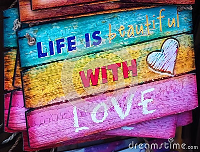 Wooden sign life is beautiful with love Stock Photo