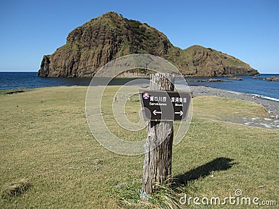 Wooden sign showing the way on a Japanese rocky coast Stock Photo