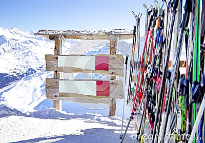 Wooden sign for text near ski and ski pole and ski equipments wint mountains on a background Stock Photo