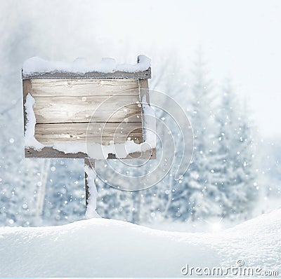 Wooden signboard in snow .Christmas banner. Stock Photo