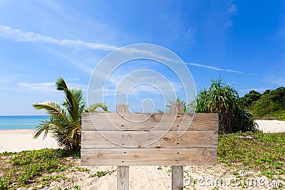 wooden signboard on tropical beach for summer background. Stock Photo