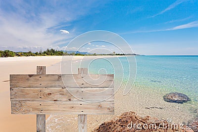 wooden signboard on tropical beach for summer background. Stock Photo