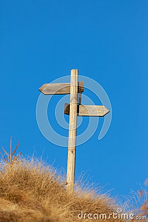 Wooden signpost and blue sky. Stock Photo