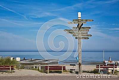 Wooden signpost showing in multiple different directions at beach on island Texe Editorial Stock Photo