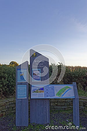 Wooden Signs with leaflets and Information on the Scottish National Nature Reserve at St Cyrus Beach Editorial Stock Photo
