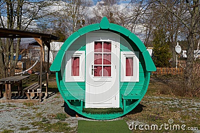 Wooden sleeping barrel on a campsite in Germany Stock Photo