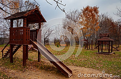 wooden slide in the children's park in autumn Stock Photo