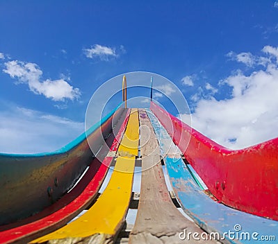 A wooden slide worn out of colors Stock Photo