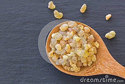 Wooden spoon of Aromatic yellow resin gum from Sudanese Frankincense tree, incense made of Boswellia sacra tree Stock Photo