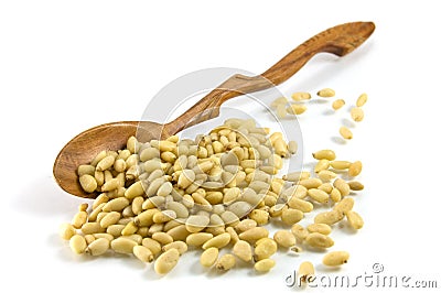 Wooden spoon and cedar nutlets Stock Photo