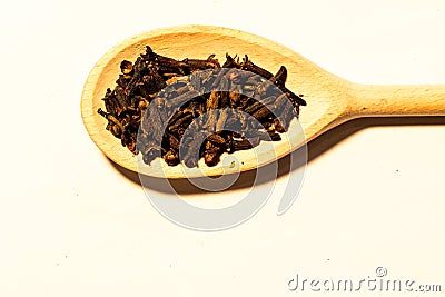 Wooden spoon with seeds cloves Stock Photo