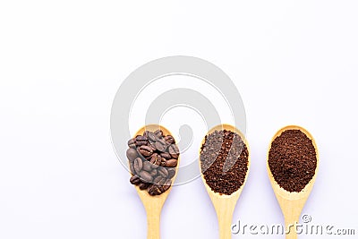 Wooden spoons filled with coffee bean and crushed ground coffee Stock Photo
