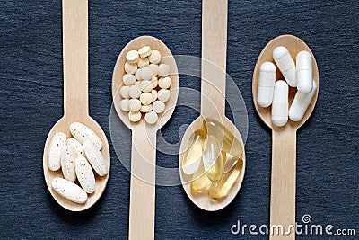 Different healthy supplements on wooden spoons Stock Photo