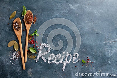 Wooden spoons with spices and recipe word Stock Photo