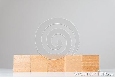 Wooden square cube figures in line isolated Stock Photo