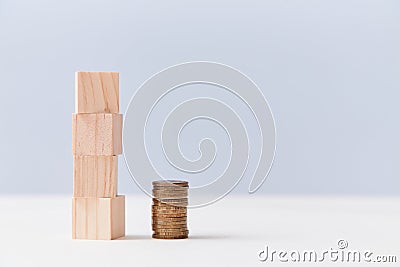 Wooden stack of cubes, pile of coins. Finance mockup template. Economic growth or crisis. Increase or decrease income Stock Photo