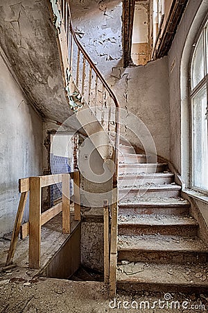 Wooden stairs in an abandoned house Stock Photo