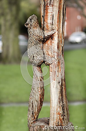 Wooden statue of squirrel, park decoration on wooden post. Manchester England. Stock Photo