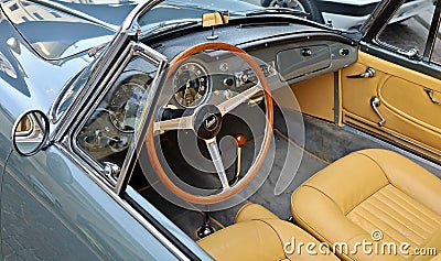 Wooden steering wheel, dash and brown leather interior of Lancia Aurelia, luxury convertible car from Fifties Editorial Stock Photo