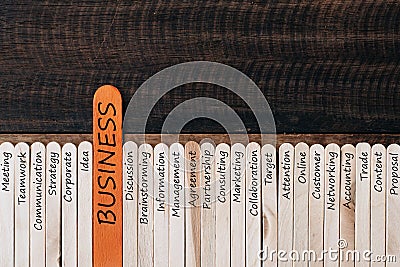 Wooden stick with Business related word on wooden table background Stock Photo