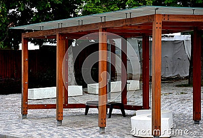 Wooden structure of the bus stop, the shelter of the gazebo pergola. the roof and walls are lined with glass. the glass is anchore Stock Photo