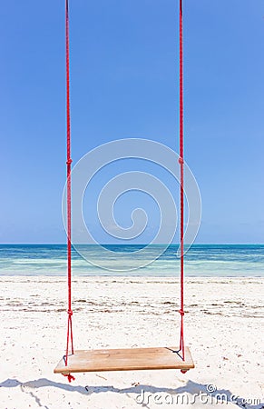 Wooden swing on the beach. Swing on scenic seascape. Idyllic exotic resort. Tropical paradise. Empty swing. Romantic vacations. Stock Photo