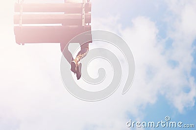 Legs hanging in the skies. Dreamer man sits on swing Stock Photo