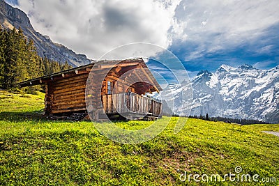 Wooden Swiss chalet in Swiss Alps near Kandersteg and Oeschinnensee, Switzerland, Europe. Stock Photo