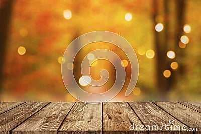 Wooden table with blurred autumn forest background Stock Photo