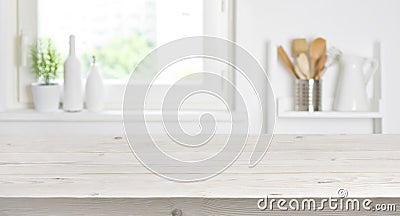 Wooden table on blurred background of kitchen window and shelves Stock Photo