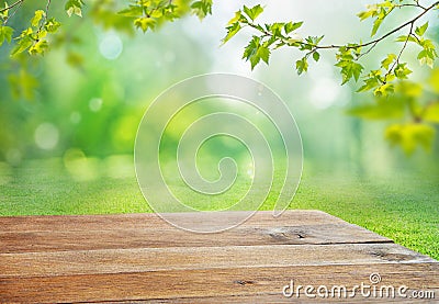 wooden table and blurred natural background with tree branches and grass Stock Photo