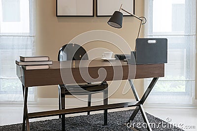 Wooden table and books in modern working room Stock Photo