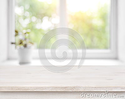 Wooden table on defocused summer window with flower pot background Stock Photo