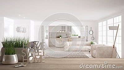 Wooden table, desk or shelf with potted grass plant, house keys and 3D letters home sweet home, over scandinavian living room with Stock Photo