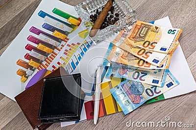 50 and 20 euro banknotes ashtray and cigar with statistics and wallet Stock Photo