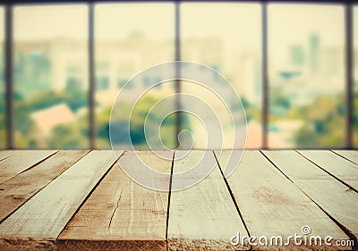 Wooden table in front of abstract Blur white green background from office window Stock Photo