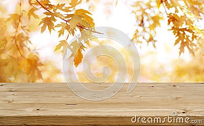 Wooden table in front of abstract blurred colorful autumn background Stock Photo