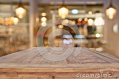 wooden table in front of abstract restaurant lights background Stock Photo