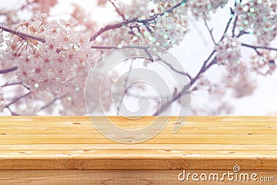 wooden table in front of white cherry tree Stock Photo