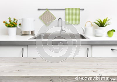 Wooden table on kitchen sink interior background Stock Photo