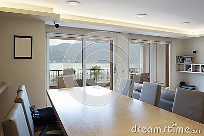 Wooden table with leather chairs with lake view window Stock Photo